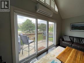 Blue Mountains townhouse for rent - A living room with a sliding glass door leading to a deck.