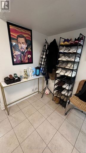 Markham (Royal Orchard) apartment for rent - A room with a shoe rack and a painting of a man drinking wine.