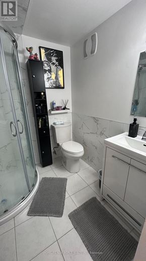 Markham (Royal Orchard) apartment for rent - A white bathroom with a glass shower door and a white toilet.