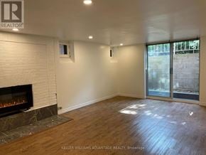 Toronto (Casa Loma) multi-family for rent - A room with a fireplace and a sliding glass door.