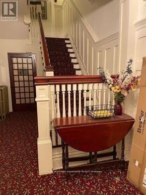 Toronto (Casa Loma) multi-family for rent - A wooden table with a basket of flowers on top of it.