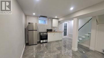 Toronto (Annex) townhouse for rent - A modern kitchen with a stainless steel refrigerator and white cabinets.