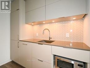 Toronto (Waterfront Communities) condo for rent - A kitchen with a sink and a stove top oven.