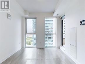 Mississauga (Creditview) condo for rent - A spacious, well-lit room with a large window and a view of a building outside.