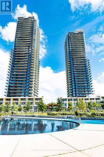 Toronto (Bayview Village) condo for rent - Two tall buildings with balconies are reflected in a pool.