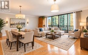 Toronto (Waterfront Communities) condo for rent - A well-lit living room with a dining table and chairs.