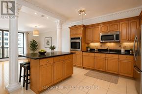 Toronto (Waterfront Communities) condo for rent - A kitchen with wooden cabinets and a black countertop.