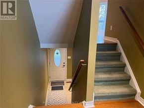 Markham (Royal Orchard) townhouse for rent - A staircase with a blue carpet and a wooden handrail.