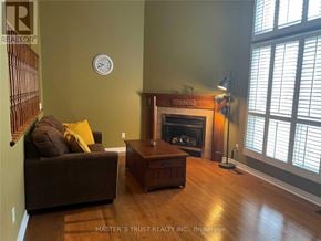 Markham (Royal Orchard) townhouse for rent - A living room with a fireplace and a couch.