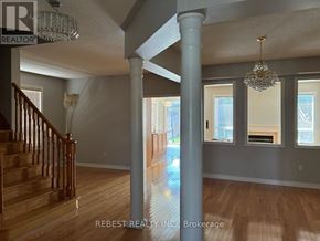 Brampton (Bramalea North Industrial) apartment for rent - A large open room with a staircase and a chandelier.