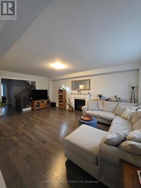 Woodstock (Woodstock - North) apartment for rent - A living room with a grey couch and a fireplace.