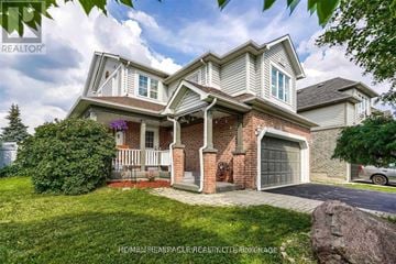 Brampton (Sandringham-Wellington) apartment for rent - A house with a brick pillar and a garage door.