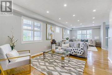 Brampton (Sandringham-Wellington) apartment for rent - A living room with a white sofa and a glass coffee table.