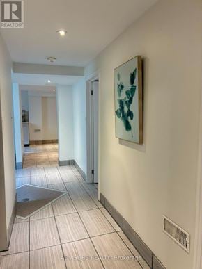 Burlington (Mountainside) apartment for rent - A hallway with a painting on the wall and a floor drain.