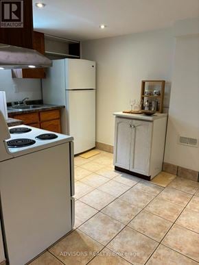 Burlington (Mountainside) apartment for rent - A kitchen with a white refrigerator and a white cabinet with a shelf on top.