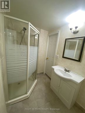 Mississauga (Meadowvale) apartment for rent - A bathroom with a walk in shower and a sink.