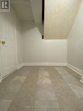 Mississauga (Meadowvale) apartment for rent - A hallway with tiled floors and white walls.