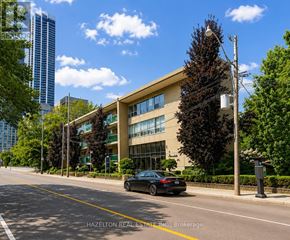 Toronto (Rosedale-Moore Park) condo for rent - A car is parked on the side of a street in front of a building with the words "HAZELTON REAL ESTATE INC." on it.