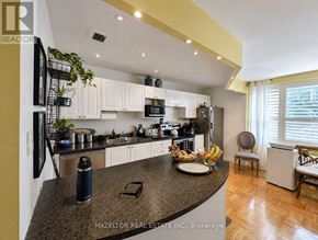Toronto (Rosedale-Moore Park) condo for rent - A modern kitchen with granite countertops and stainless steel appliances.