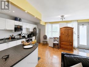 Toronto (Rosedale-Moore Park) condo for rent - A kitchen with a table and chairs in front of a window.