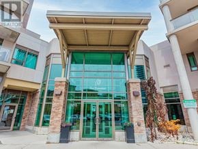 Pickering (Bay Ridges) condo for rent - The front of a building with a glass entrance and a sign that says "MA" on it.