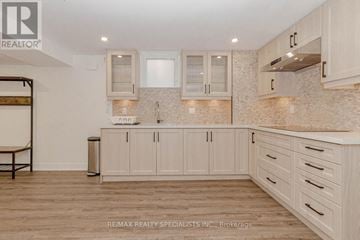 Mississauga (Central Erin Mills) apartment for rent - A kitchen with white cabinets and a wooden floor.