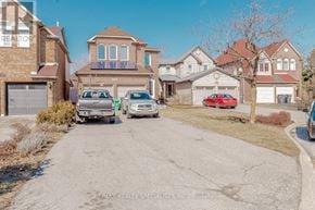 Mississauga (Central Erin Mills) apartment for rent - A residential street with houses and parked cars.