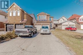 Mississauga (Central Erin Mills) apartment for rent - A residential area with houses and parked cars.