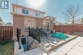 Mississauga (Central Erin Mills) apartment for rent - A house with a blue door and a fence in front of it.