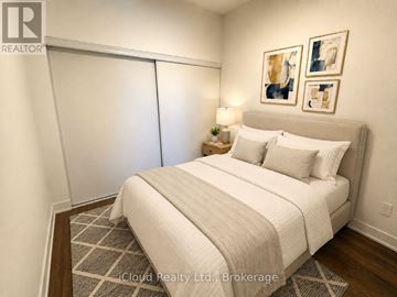 Milton (Tm Timberlea) condo for rent - A bedroom with a large bed and a lamp on the side table.