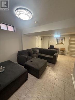Toronto (West Humber-Clairville) apartment for rent - A living room with a couch, ottoman, and a picture on the wall.
