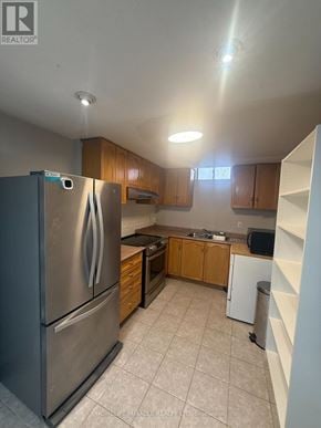 Toronto (West Humber-Clairville) apartment for rent - A kitchen with a refrigerator, microwave, and oven.
