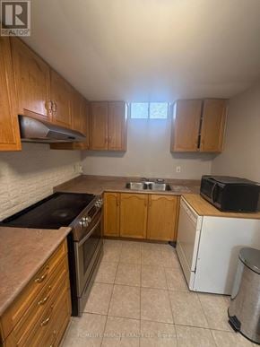 Toronto (West Humber-Clairville) apartment for rent - A kitchen with wooden cabinets and a black stove top oven.