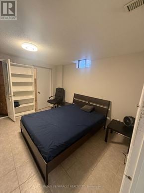 Toronto (West Humber-Clairville) apartment for rent - A bedroom with a bed, chair, and wardrobe.
