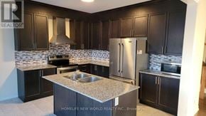Clarington (Bowmanville) apartment for rent - A kitchen with dark wood cabinets and a granite countertop.