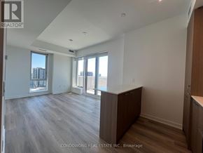 Toronto (Regent Park) condo for rent - A spacious room with wood flooring and large windows.