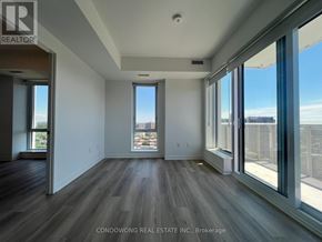 Toronto (Regent Park) condo for rent - A room with a view of the city through large windows.