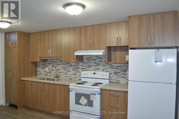 Markham (Middlefield) apartment for rent - A kitchen with wooden cabinets and a white fridge.