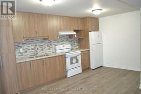 Markham (Middlefield) apartment for rent - A kitchen with wooden cabinets and a white fridge.