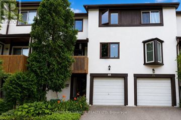 Mississauga (Meadowvale) townhouse for rent - A white building with a tree in front of it.