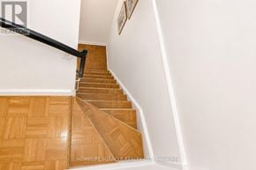 Mississauga (Meadowvale) townhouse for rent - A staircase with wooden steps and a black handrail.