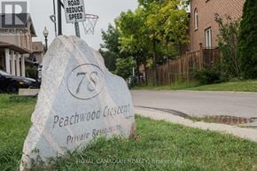 Hamilton (Stoney Creek) apartment for rent - A large rock with the number 78 and the words Peachwood Crescent Private Residences etched into it.