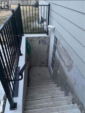 Hamilton (Lawfield) apartment for rent - A stairway with a black railing leading to a concrete area.