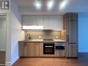 Toronto (Forest Hill South) condo for rent - A modern kitchen with wooden cabinets and stainless steel appliances.