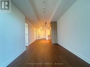 Toronto (Forest Hill South) condo for rent - A long hallway with wood floors and white walls.