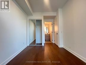 Toronto (Forest Hill South) condo for rent - A hallway with wood floors and white walls.