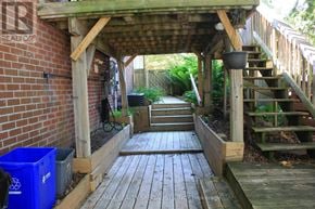 Barrie (Cundles East) apartment for rent - A room with a fireplace and a window with curtains.