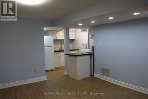 Barrie (Cundles East) apartment for rent - A kitchen with white cabinets and a countertop is shown in the image.
