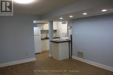 Barrie (Cundles East) apartment for rent - A kitchen with white cabinets and a countertop is shown in the image.