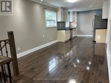 Toronto (Danforth Village-East York) apartment for rent - A spacious kitchen with wood flooring and a dining area.